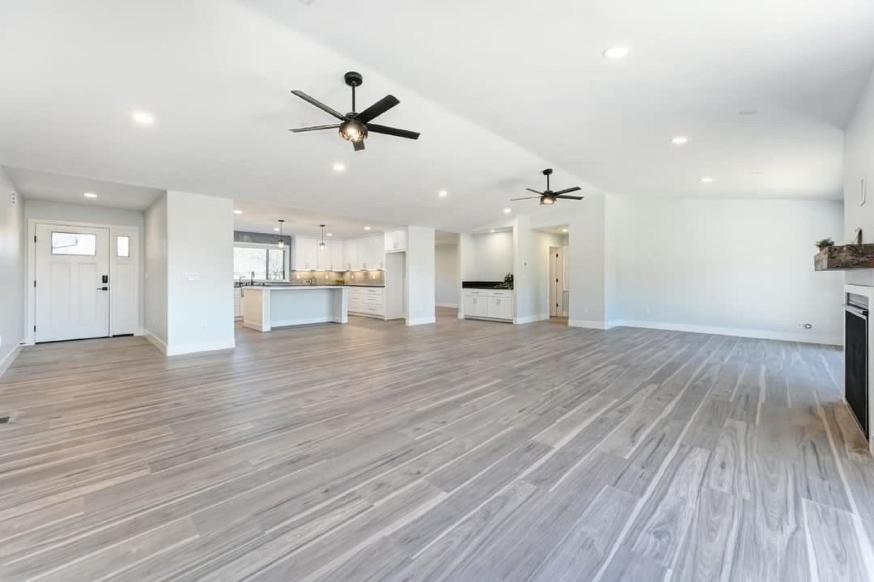 Finished Auburn living space with recessed lighting and ceiling fans