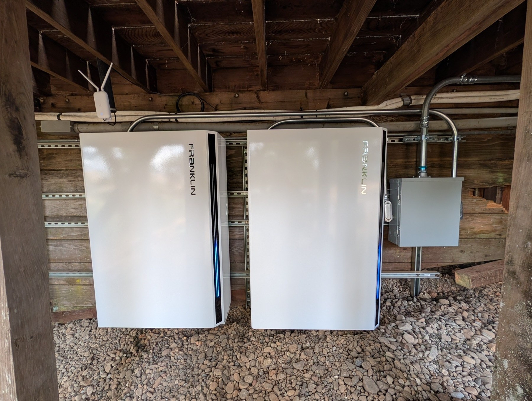 Two FranklinWH batteries installed beneath a deck