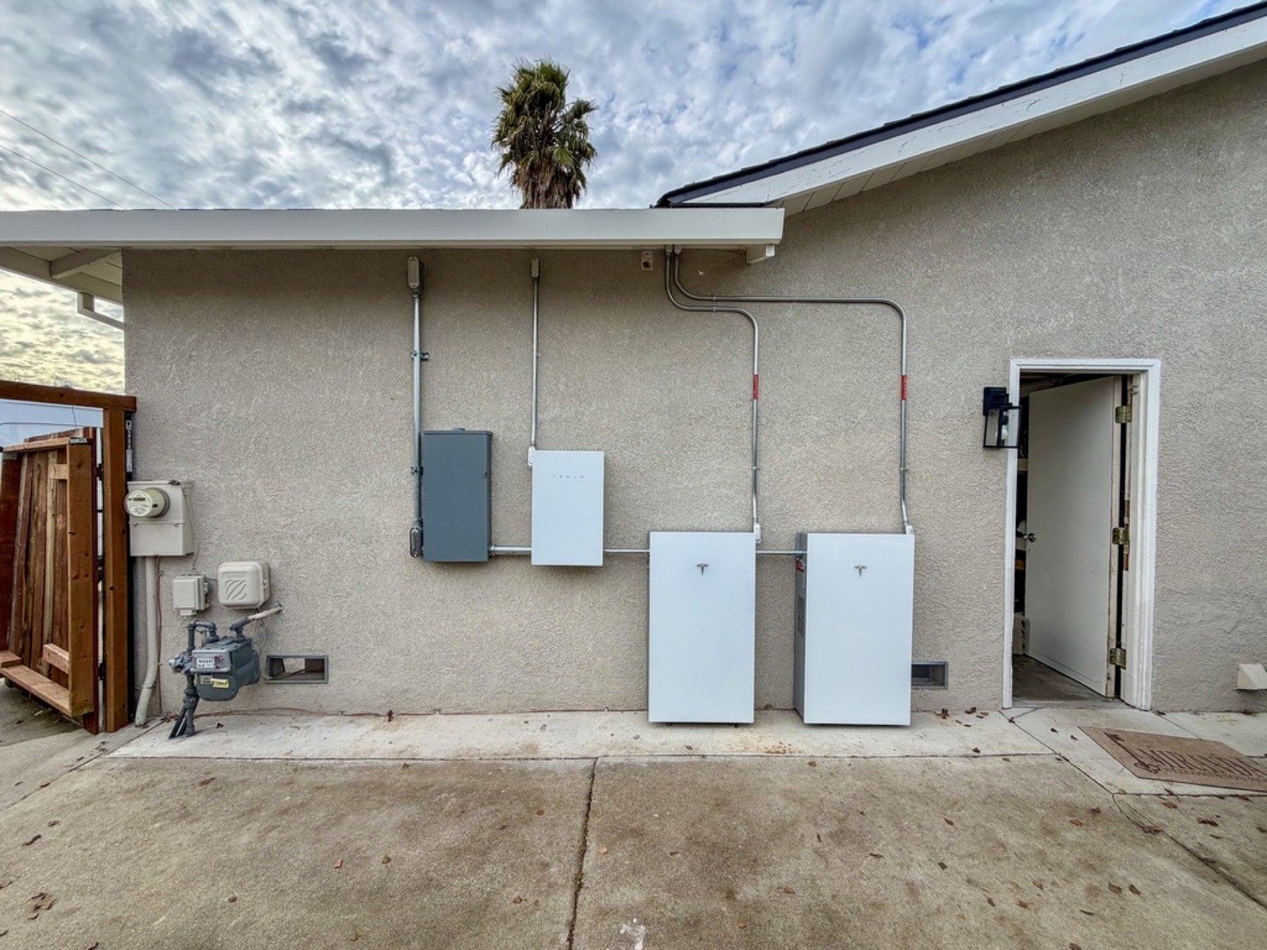 Tesla Powerwall 3 equipment installed beside a residential electrical panel