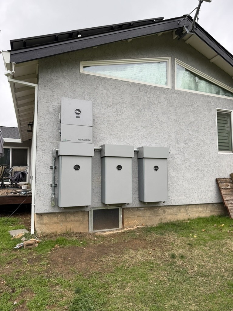 EG4 whole-home backup batteries installed on an exterior wall